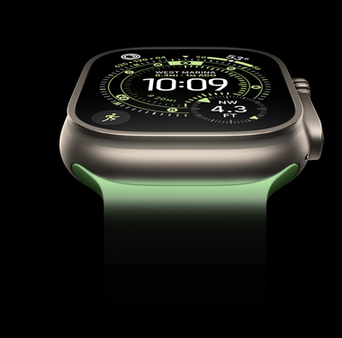 A close-up of a Natural Titanium Apple Watch Ultra 3 on a black background. The display shows the time and other dynamic info.