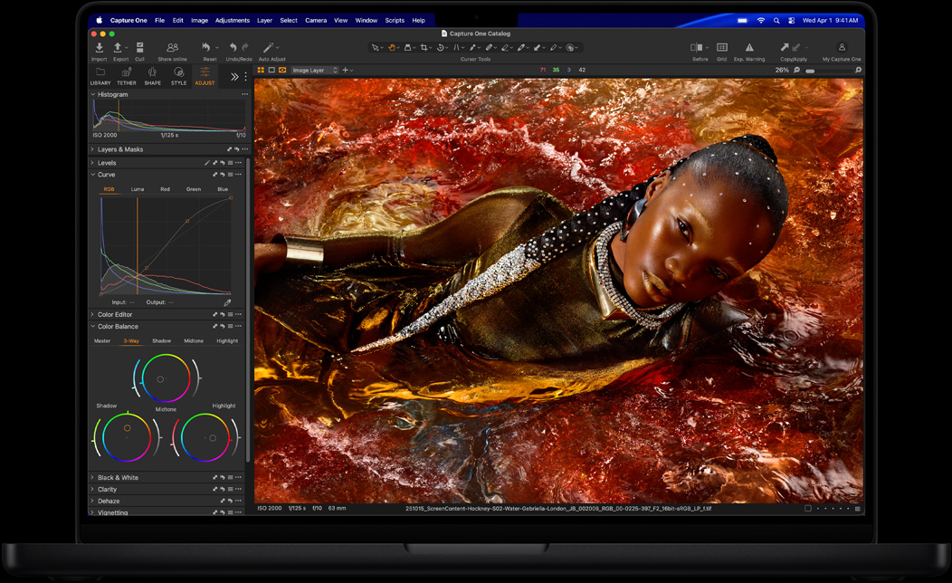 MacBook Pro screen of a photo of a person being edited in Capture One