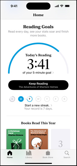 iPhone screen showing the Reading Goals interface in the Books app. At the top, there is a progress ring. Below the progress ring is the weekly reading streak tracker. At the bottom is the Books Read This Year section, which includes a row of two books, with an empty slot for a third