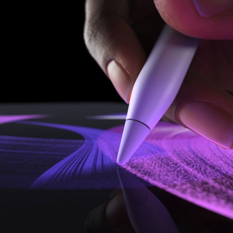 Person uses Apple Pencil Pro in Procreate, creating a vibrant brush line