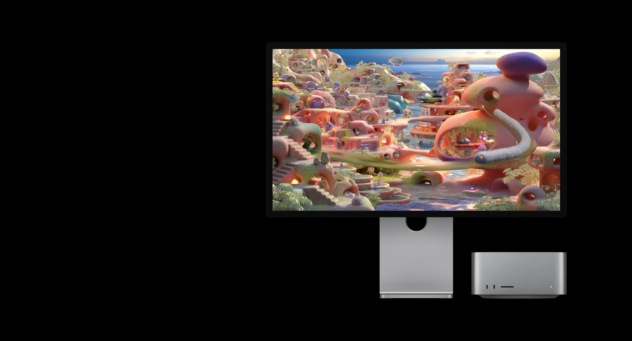 In a cartoon landscape on Studio Display XDR with Mac Studio tucked underneath, a worm-like creature appears to exit a tunnel and move across the screen